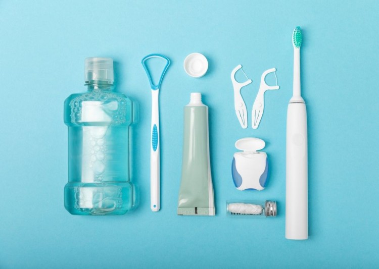 Oral hygiene tools on a blue background.