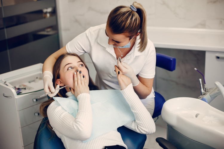 Same-day emergency dentist in Toronto examining and treating a patient during an urgent dental care visit in a clinic
