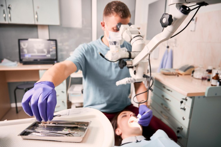 Periodontist examining and treating a patient in a modern dental clinic with professional dental tools and equipment for gum disease care and oral treatment.